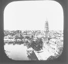 View of the city, showing the clock tower and a portion of the temple tank, Umritsur.