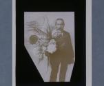 [Man holding bouquet of flowers towards camera]