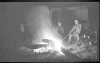 George Eastman and camping companions by campfire at night, Wyoming & Pacific Coast Trip