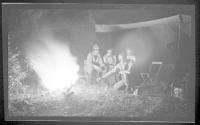 George Eastman and companions around campfire at night, Wyoming Trip