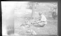 George Eastman with dog at campsite, Arizona Trip