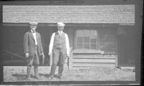 Men with guns in front of house, Oak Lodge Trip