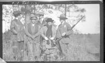 George Eastman holding rifle, with four friends, Oak Lodge Trip
