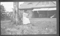 May Gifford in rocker, flying kite, Oak Lodge Trip