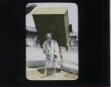 [Man carrying furniture on "Jigae"]