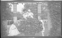 Nell Newhall in Eastman's garden with Watson Newhall and the Dryden children