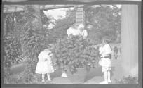 Nell and Watson Newhall in Eastman's garden with Dryden children
