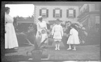 Women in Eastman's garden with Dryden children and Watson Newhall