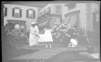 Woman in Eastman's garden with Dryden children and Watson Newhall