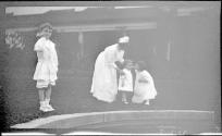 Woman in Eastman's garden with Dryden children and Watson Newhall