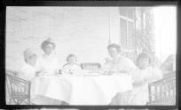 Ellen Dryden and Nell Newhall on porch with children
