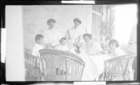 Nell Newhall on porch with children and staff