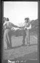 Man and woman holding tools, Oak Lodge Trip