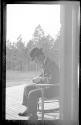 George Bonbright sitting in chair on porch, Oak Lodge Trip