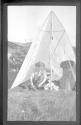 Man, perhaps George Eastman, putting on boots, Labrador Trip