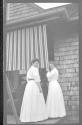 Marie Willard and May Gifford opening awning, Oak Lodge Trip