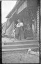 May Gifford sewing flag on porch, Oak Lodge Trip