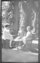 Dryden children and Watson Newhall on Eastman's porch