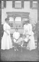Women in Eastman's garden with Dryden children and Watson Newhall