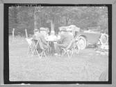 George Eastman and friends at table by automobile, Catskills Motor Trip