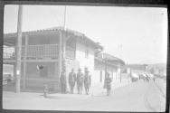 [Men in uniform in street scene]