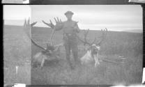 George B. Dryden with dead caribou, Alaska trip