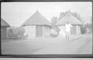 Man in front of huts, African Safari
