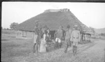 Group in front of a hut, African Safari