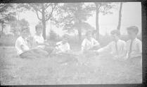 Group of boys sitting at campfire