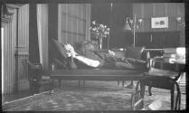 George Eastman reclining on sofa in west room