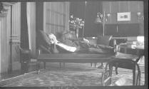 George Eastman reclining on sofa in west room