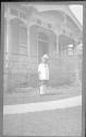 Young girl in front of house