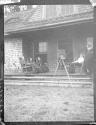 George Eastman photographing guests on porch, Oak Lodge Trip