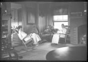 Mulligans and Hubbells resting in living room, Oak Lodge Trip