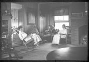 Mulligans and Hubbells resting in living room, Oak Lodge Trip