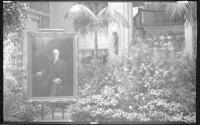 Philip Alexius de László's portrait of George Eastman displayed in conservatory