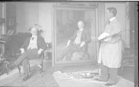 George Eastman and Charles Hopkinson with painting in conservatory