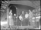 George Eastman and travel companions on train balconey, Mexican Trip