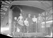 George Eastman and travel companions on train balconey, Mexican Trip