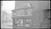 [Man on street by "The Old Curiosity Shop"]