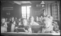 [Children & teacher in school room]