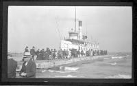 [People boarding passenger boat at dock]