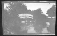 [People in boat on canal in park]