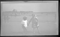 [Girls on beach, pier in distance]