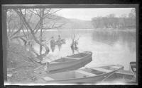 [People in rowboat along river]