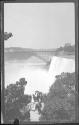 [People on overlook, falls, river gorge & bridge distant]
