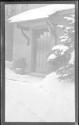 [Door of snow covered house]