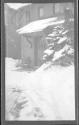 [Door of snow covered house (out of focus)]