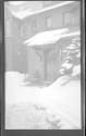 [Door of snow covered house (out of focus)]