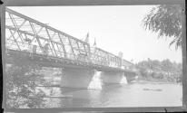 [People on tressle bridge over river]